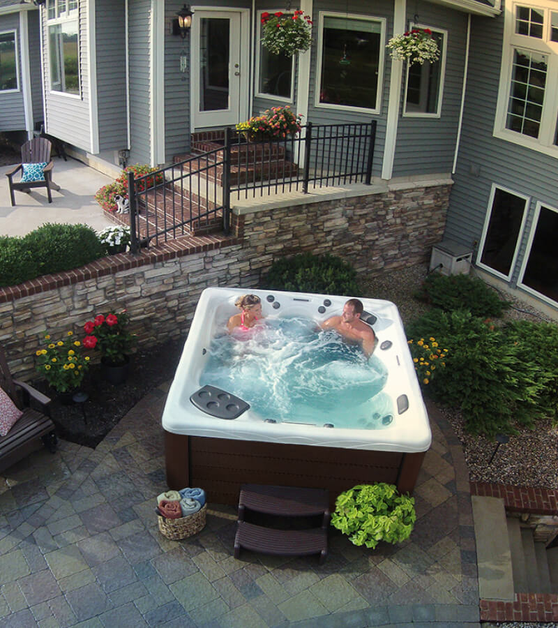 Relaxation, Just Steps Away. When planning for your hot tub, consider the proximity to your backdoor and other features of your home.