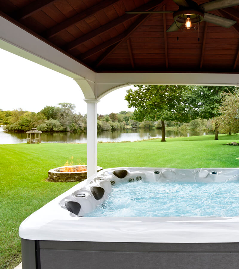 Hot Tub with a View. While relaxing in a hot tub, look out the lake and built-in fire pit.