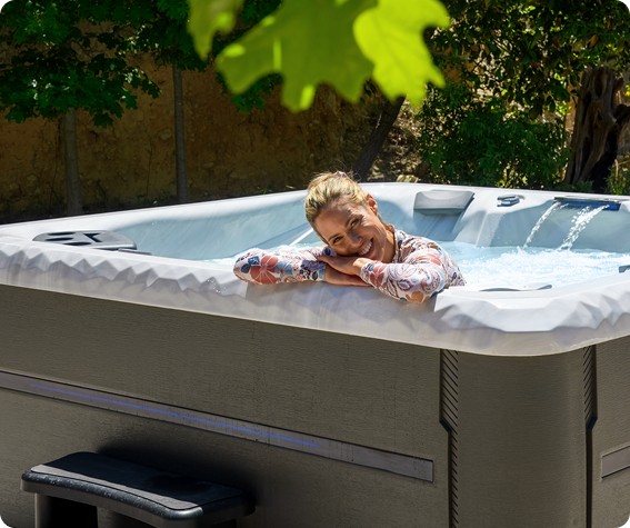 Woman in hot tub leaning on edge.