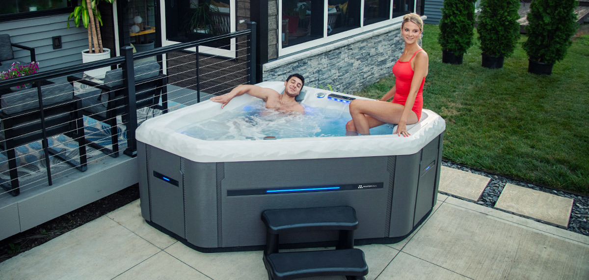 A couple enjoying their Twilight Spas 240X hot tub.