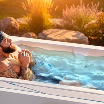 Person sitting in a cold tub.