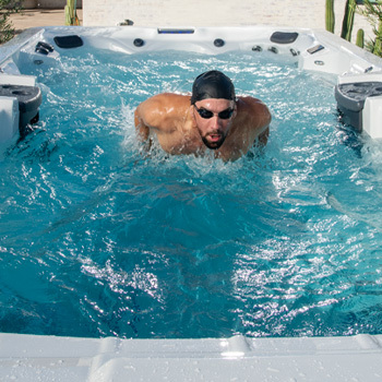 Michael Phelps swimming in a Michael Phelps Signature Swim Spa by MasterSpas.