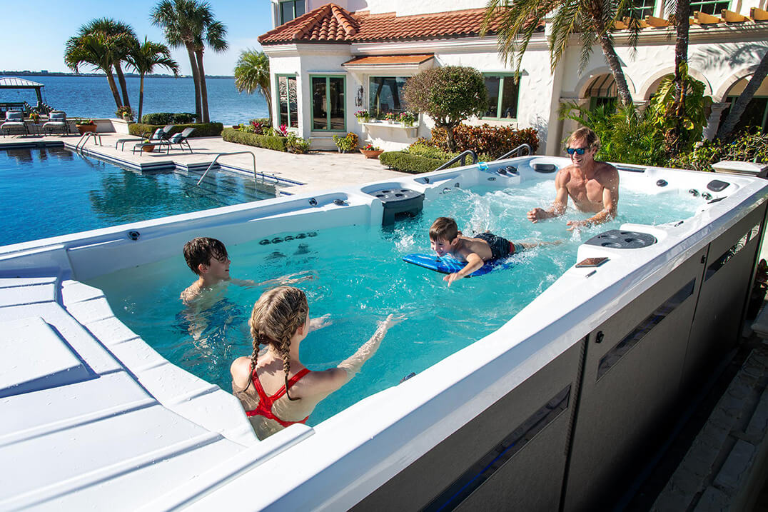 Family enjoying time together in a swim spa