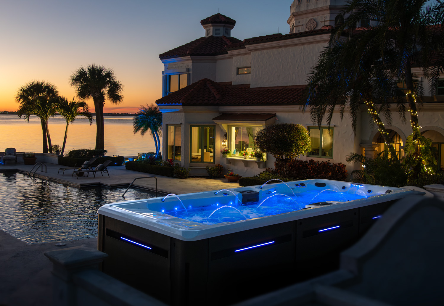 Signature Pro swim spa at night with leds on.